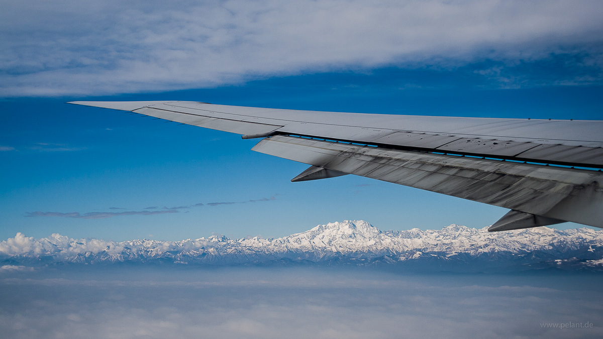 view from the plane of Alps mountains and Monte Rosa, with Boeing 767-400ER wing with raked wingtips