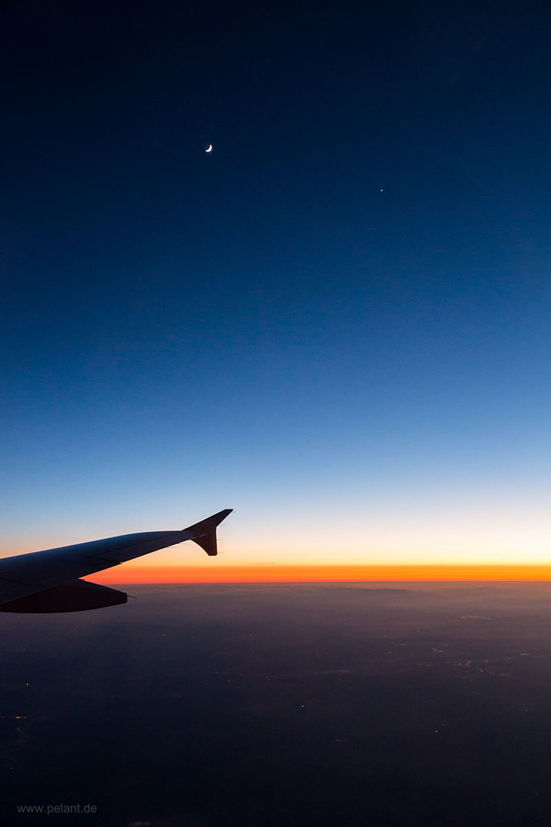 moon and venus (right) at dusk above the clouds (view from aeroplane)