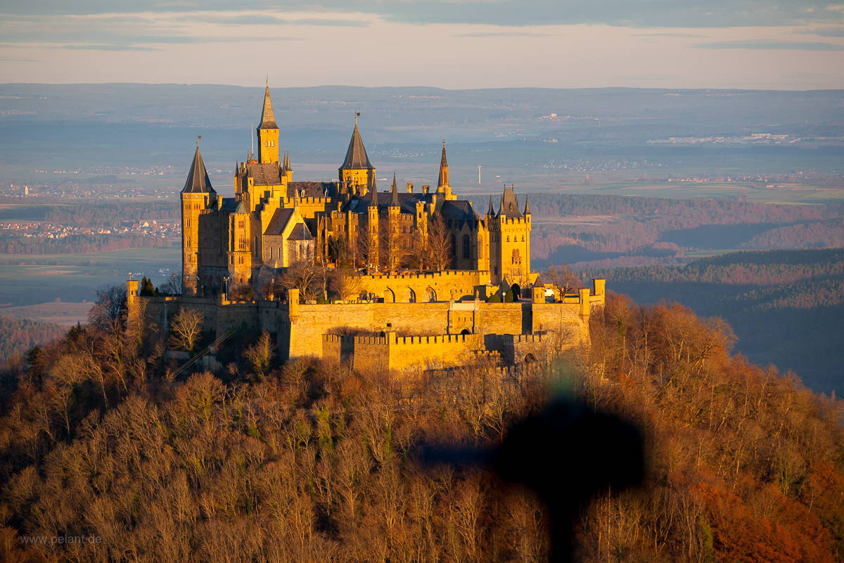 blurred camera silhouette in front of Hohenzollern castle