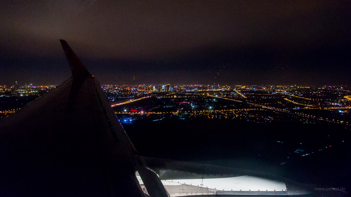 View of Beijing from an airplane window during final approach to Beijing Capital International Airport at night