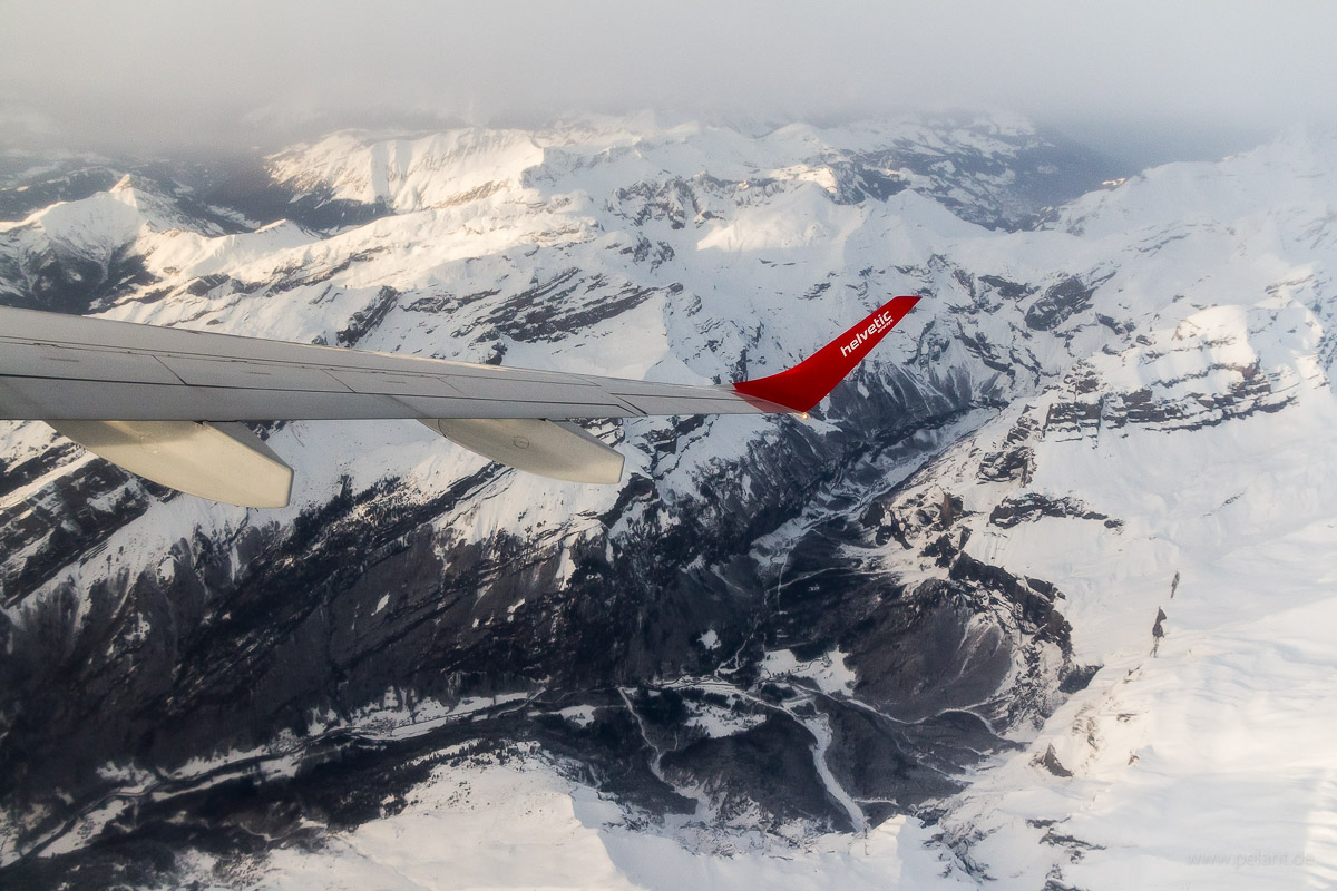 aerial view of Cirque du Fer  Cheval in winter with winglet of Helvetic Airways Embraer 190