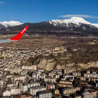Aerial view of Sion during approach of Sion Airport (from ZRH) with Helvetic Airways Embraer 190 with its winglet visible in the image